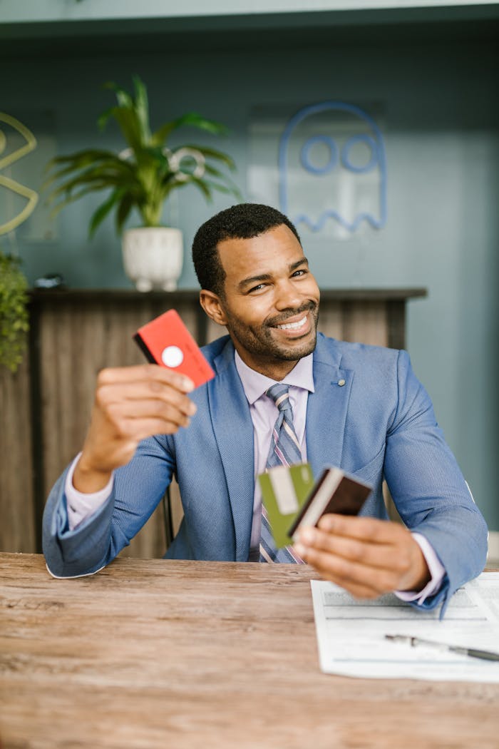A Man in a Suit Holding Credit Cards